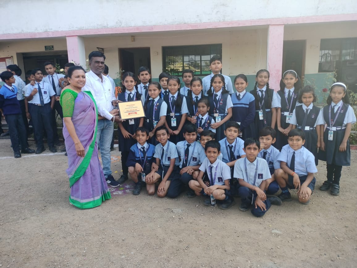 Students celebrating with award